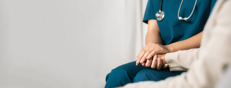 nurse holding patients hand